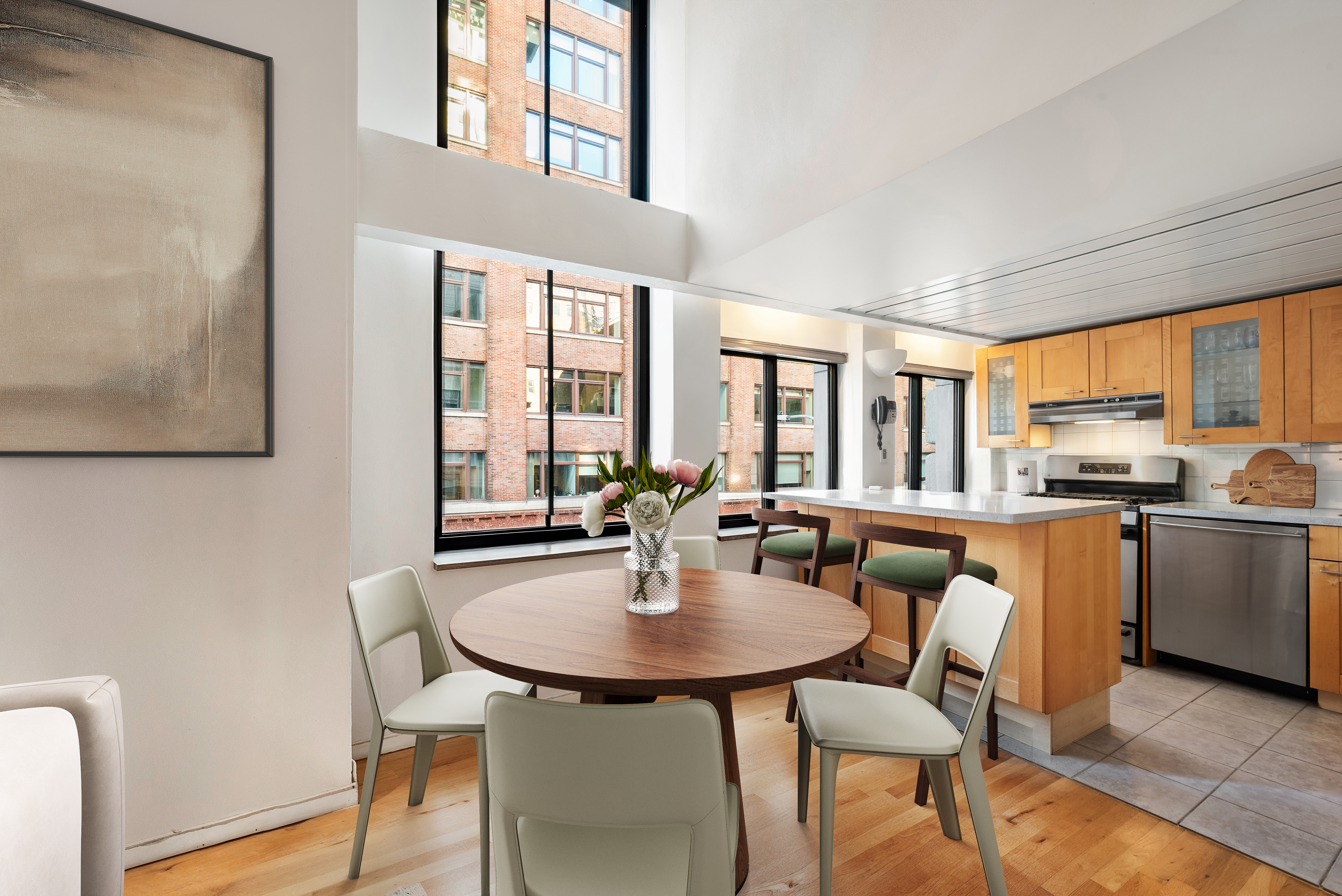 421 Hudson Street, Unit 213 Manhattan, NY 10014 - Photo 2 of 7 a dining room with furniture and window