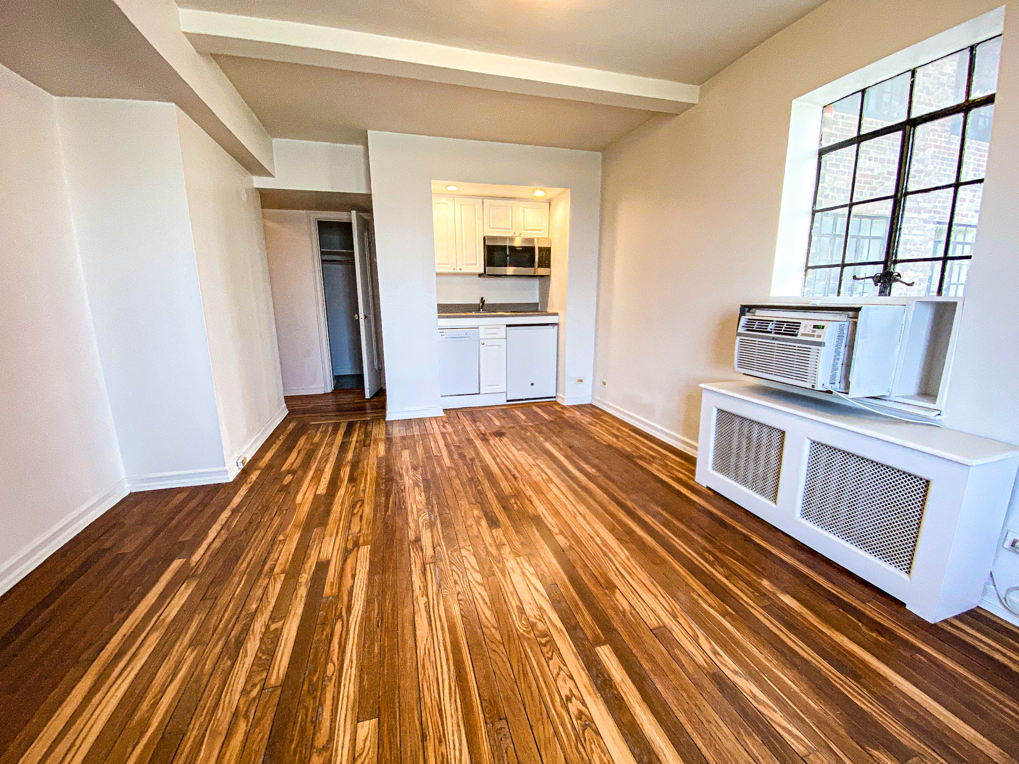 5 Tudor City Place, Unit 627 Manhattan, NY 10017 - Photo 2 of 11 a view of a living room with wooden floor
