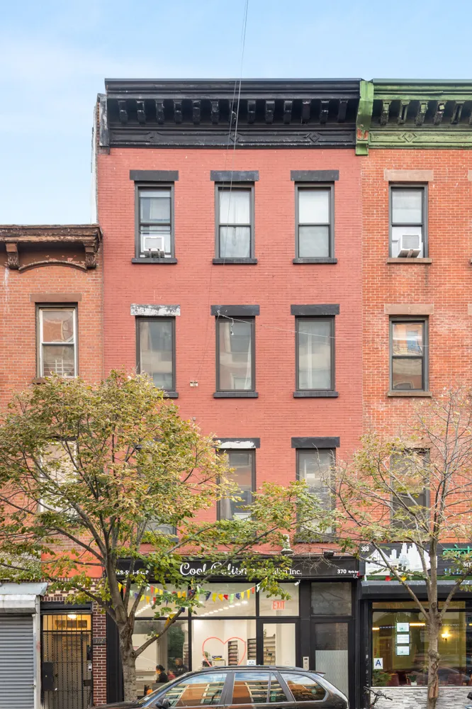 a living room with fireplace furniture and a book shelf