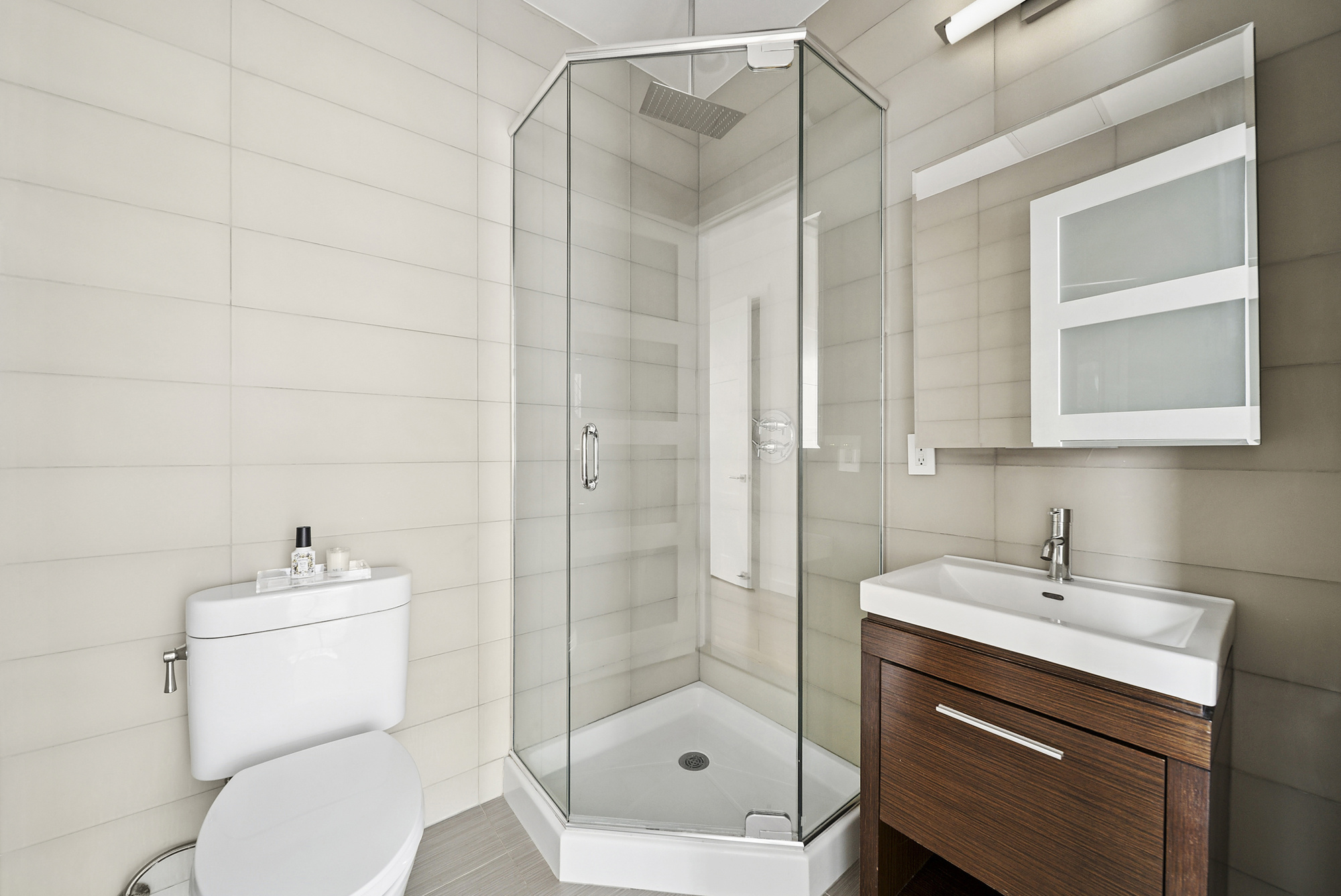 148 East 19th Street, Unit 4B Manhattan, NY 10003 - Photo 8 of 10 a bathroom with a sink toilet and shower