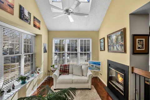a living room with furniture a flat screen tv and a fireplace