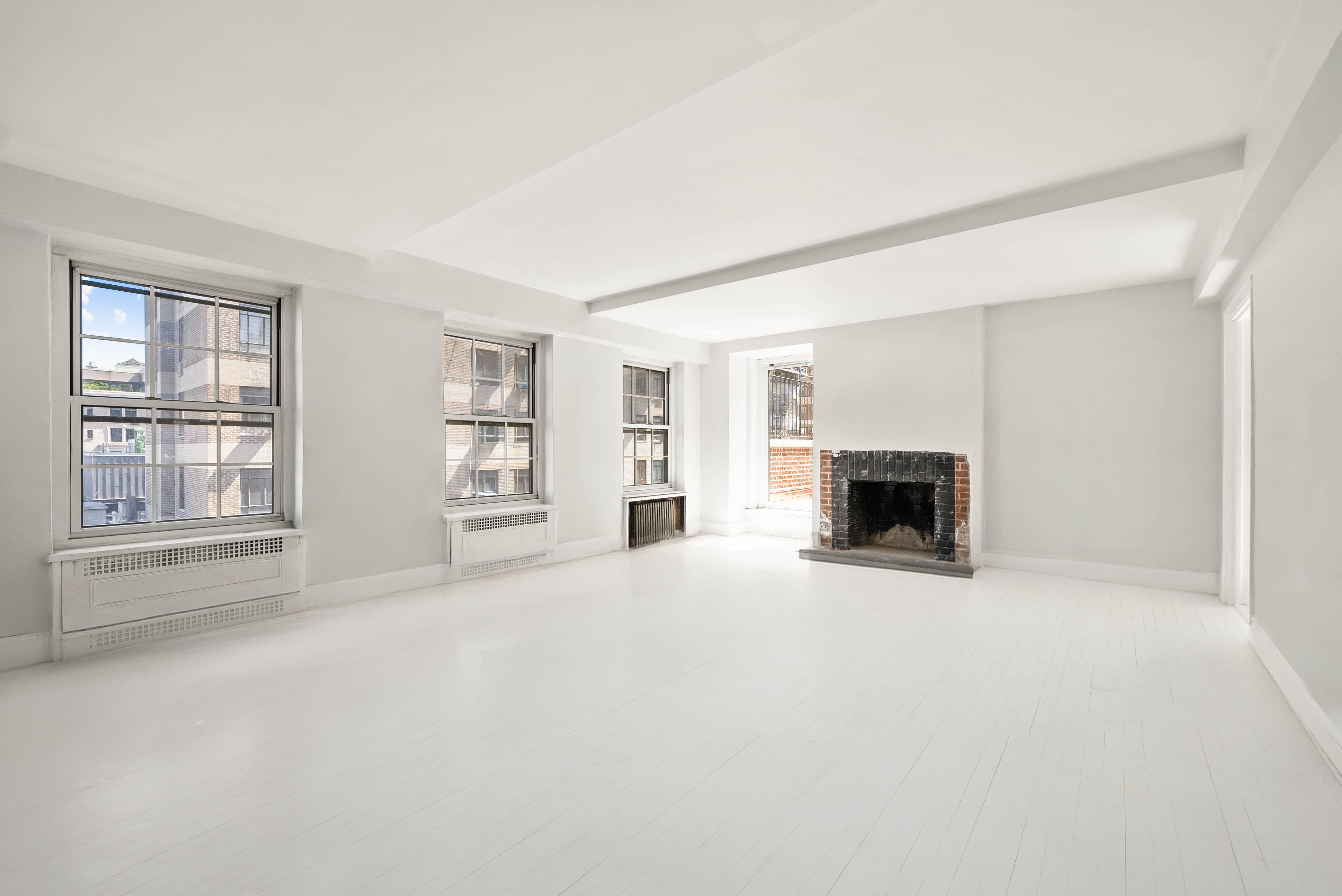 12 East 88th Street, Unit PH11/12B Manhattan, NY 10128 - Photo 2 of 22 a view of an empty room with a fireplace and a window