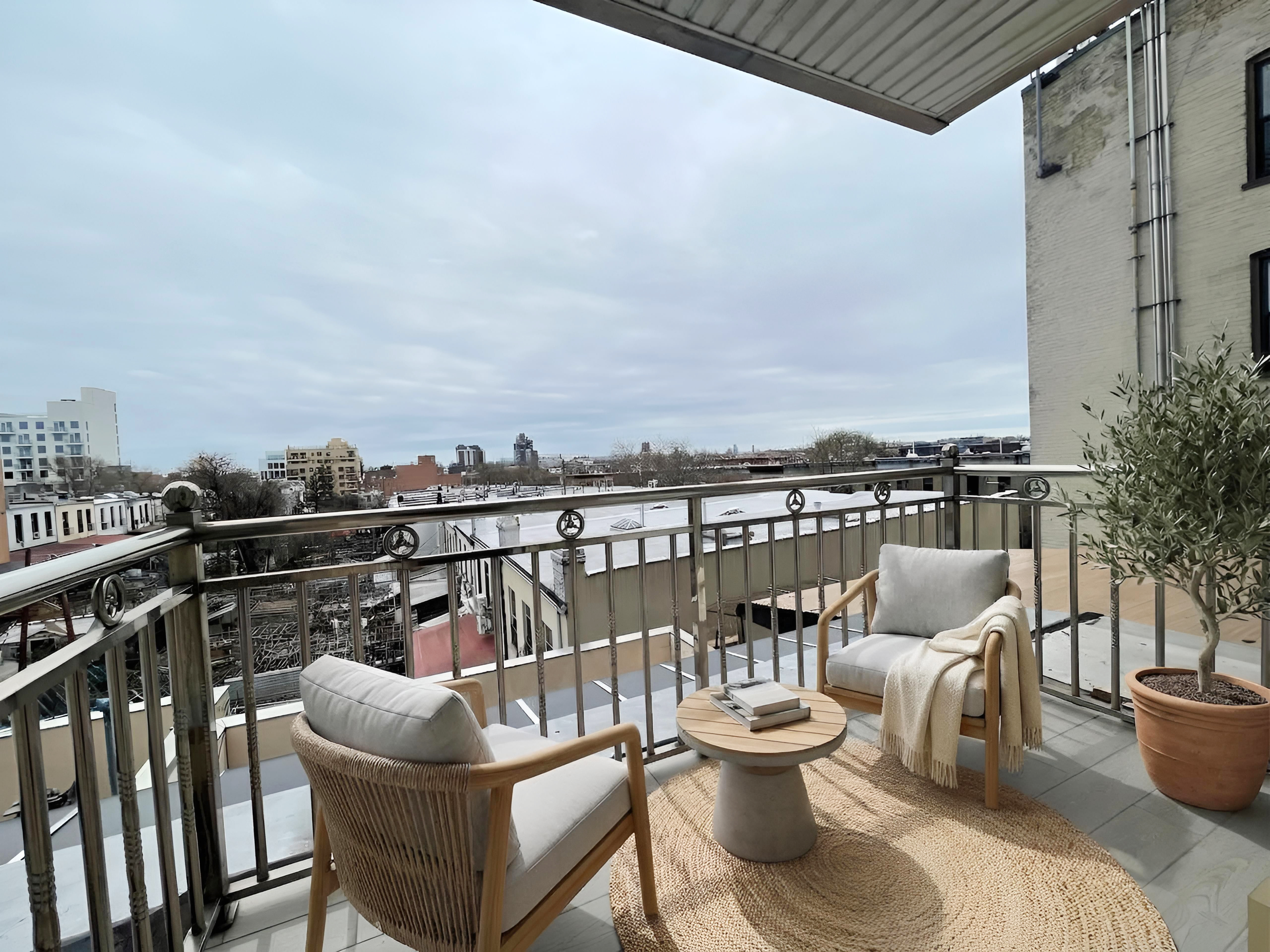 5815 6th Avenue, Unit 3B Brooklyn, NY 11220 - Photo 6 of 6 a view of a balcony with two chairs and a potted plant
