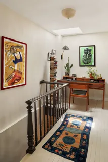 a bed room with furniture and paintings on the wall