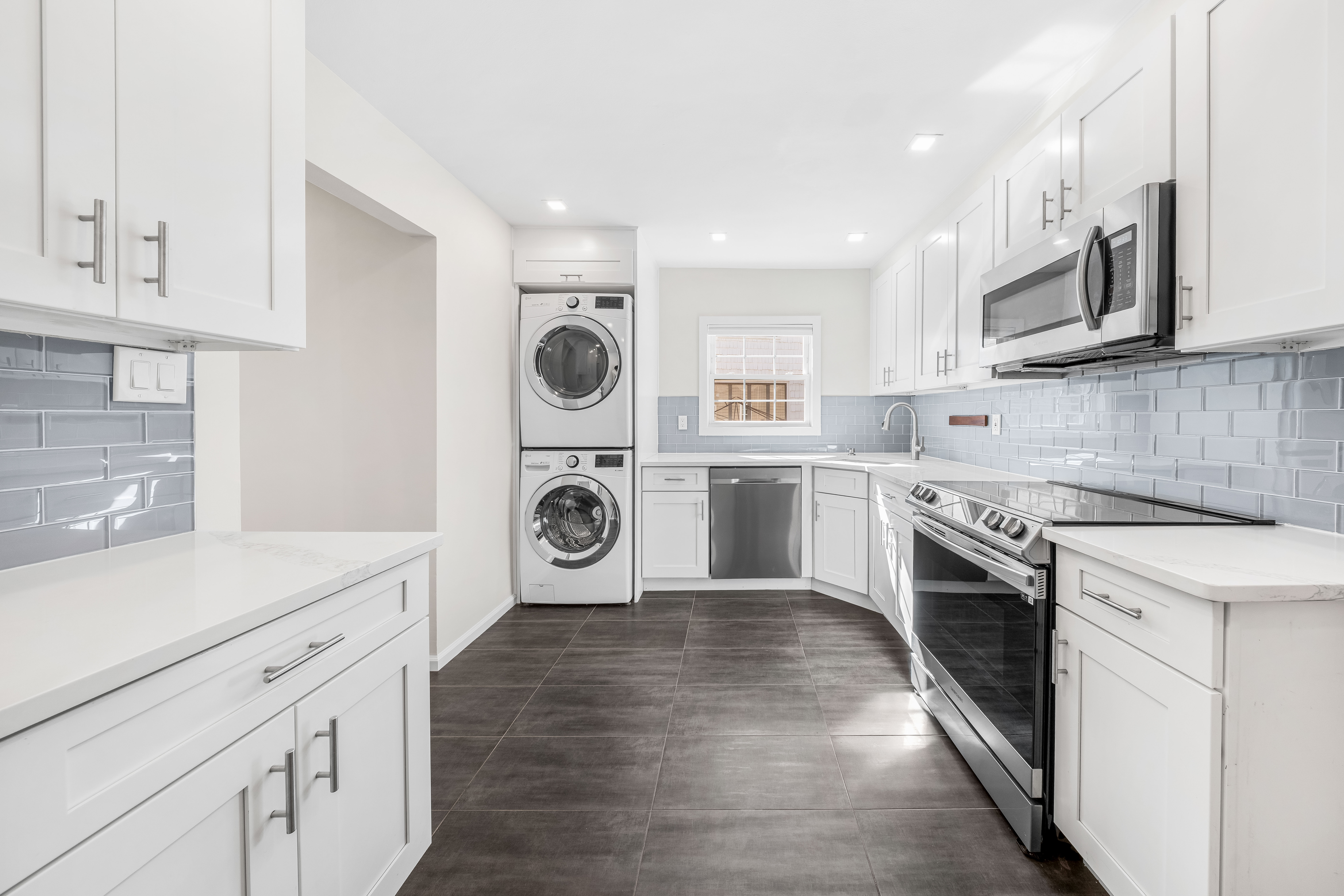 15-80 209th Street, Unit 2 Queens, NY 11360 - Photo 6 of 21 a kitchen with a stove top oven sink and cabinets