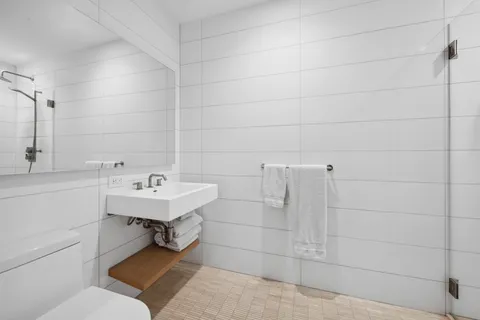 a bathroom with a sink toilet and shower