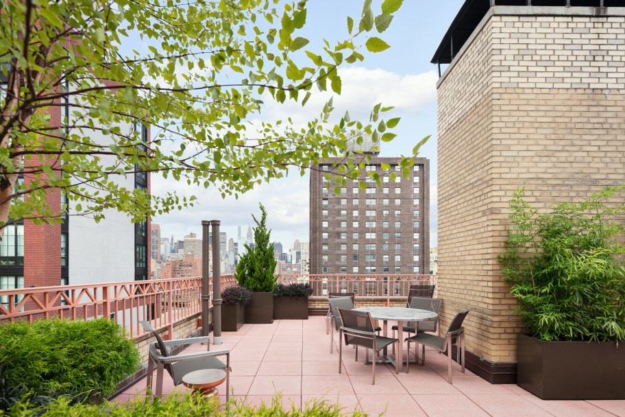 235 East 22nd Street, Unit 4M Manhattan, NY 10010 - Photo 11 of 14 a view of a patio with table and chairs and potted plants