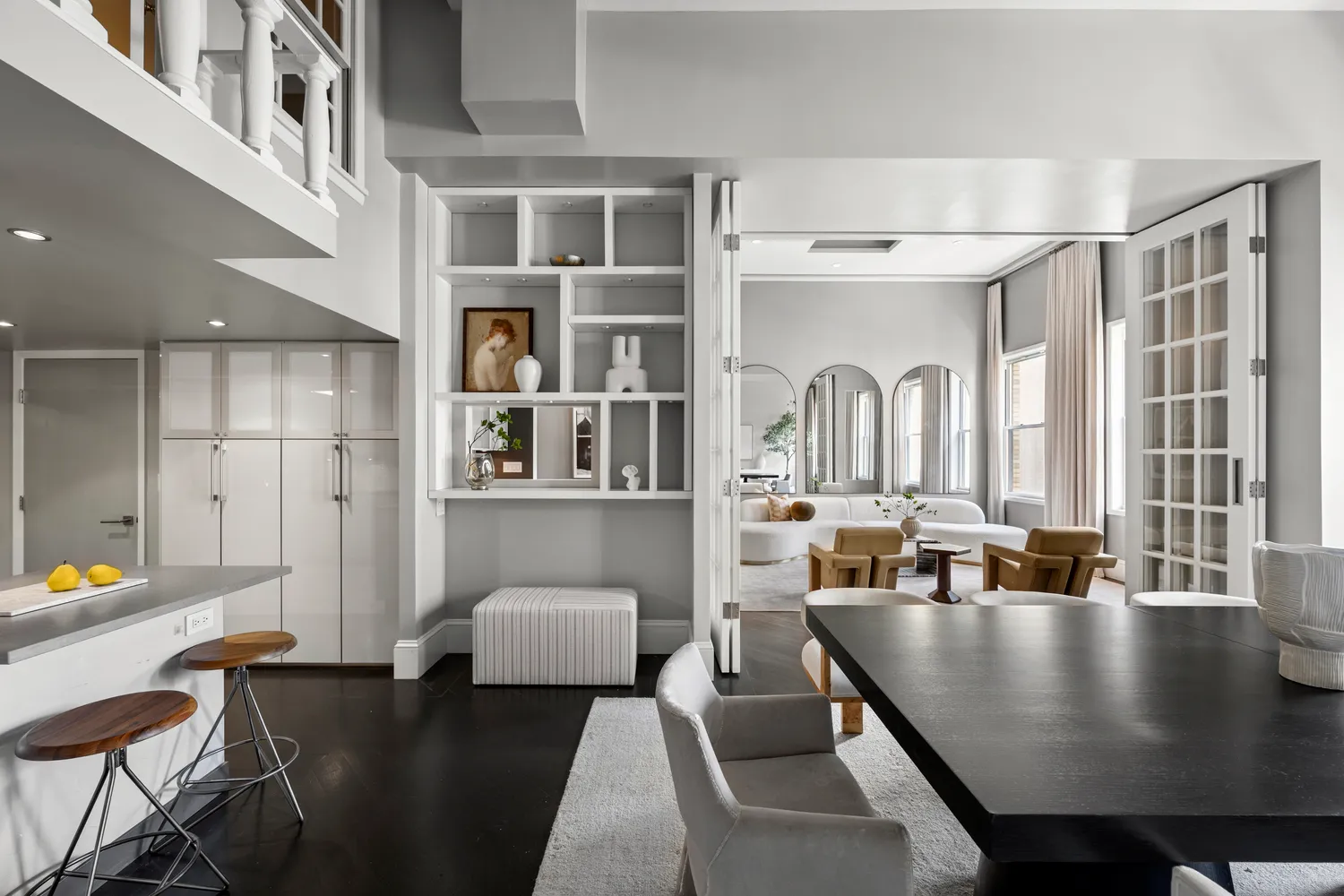 a living room with stainless steel appliances granite countertop a couch a table and chairs