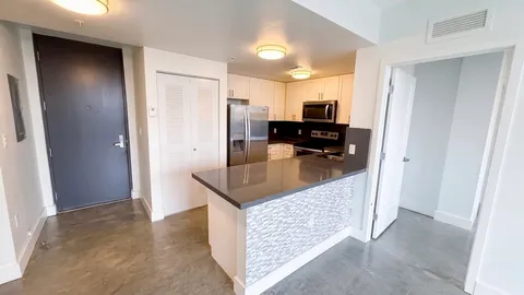 a kitchen with stainless steel appliances granite countertop a refrigerator and a stove