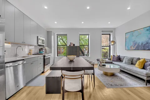 a large kitchen with a table and chairs