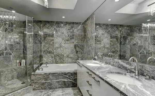 a bathroom with a granite countertop sink a mirror and a shower