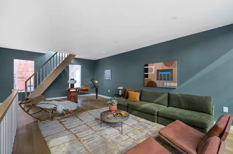 a living room with furniture and a wooden floor