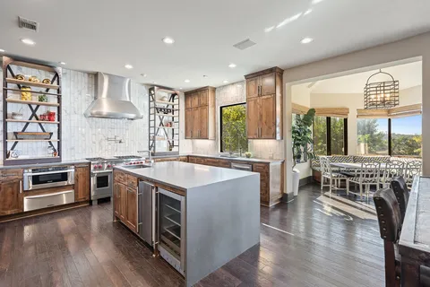 a bedroom with a large bed and a chandelier