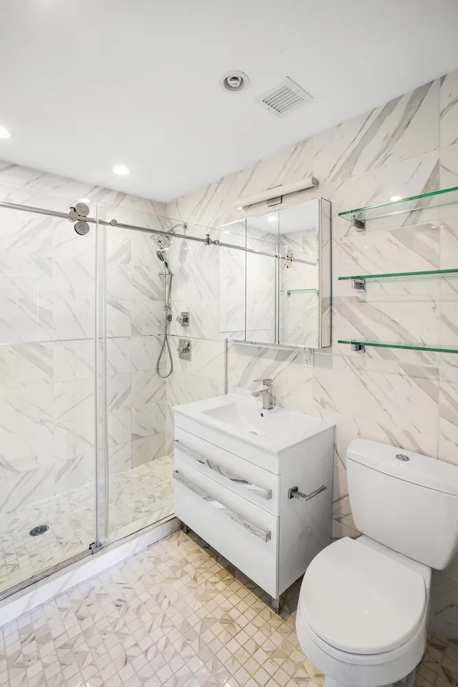 a bathroom with a sink toilet and shower