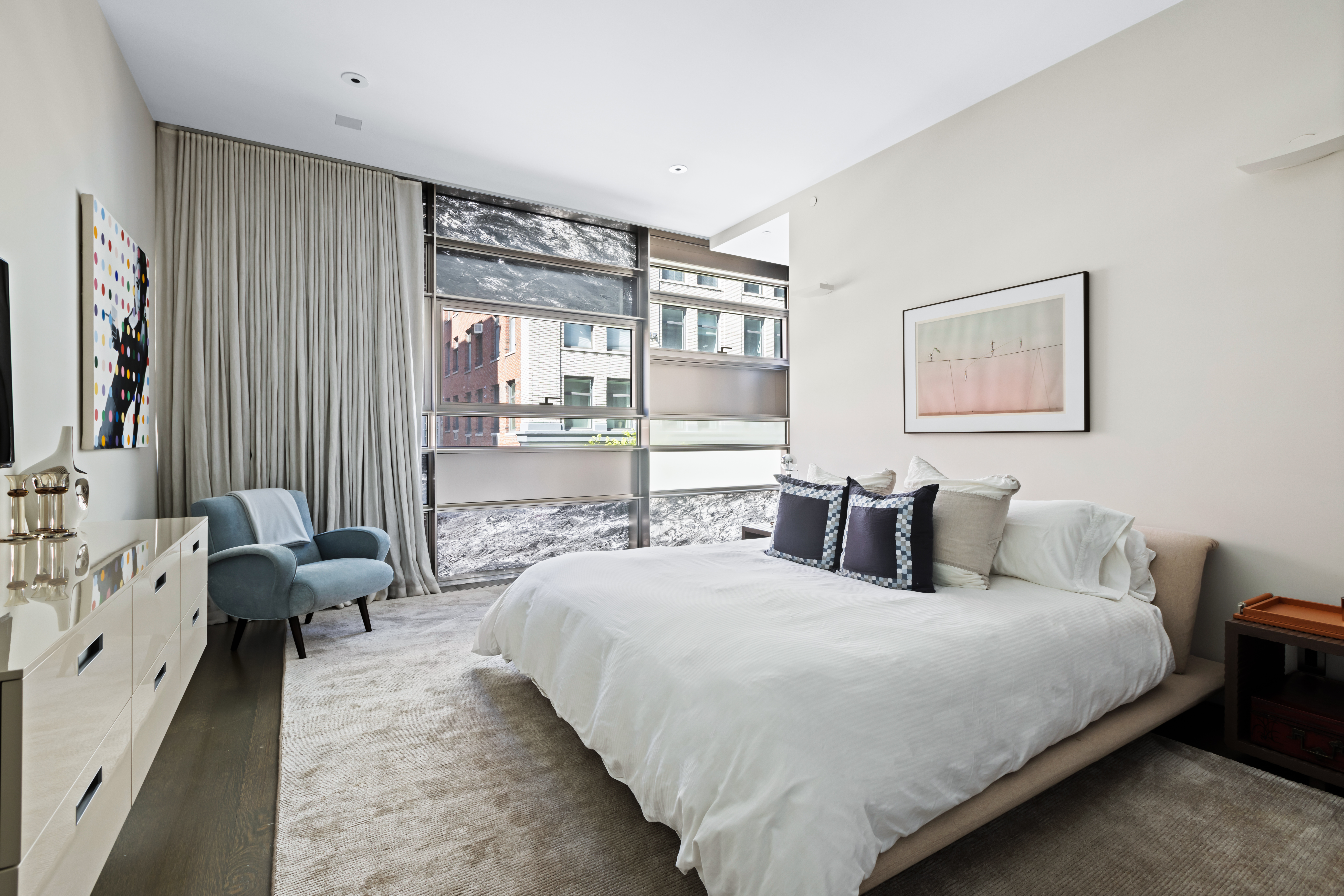 33 Vestry Street, Unit TH1 Manhattan, NY 10013 - Photo 14 of 17 a bedroom with a bed couch and large window