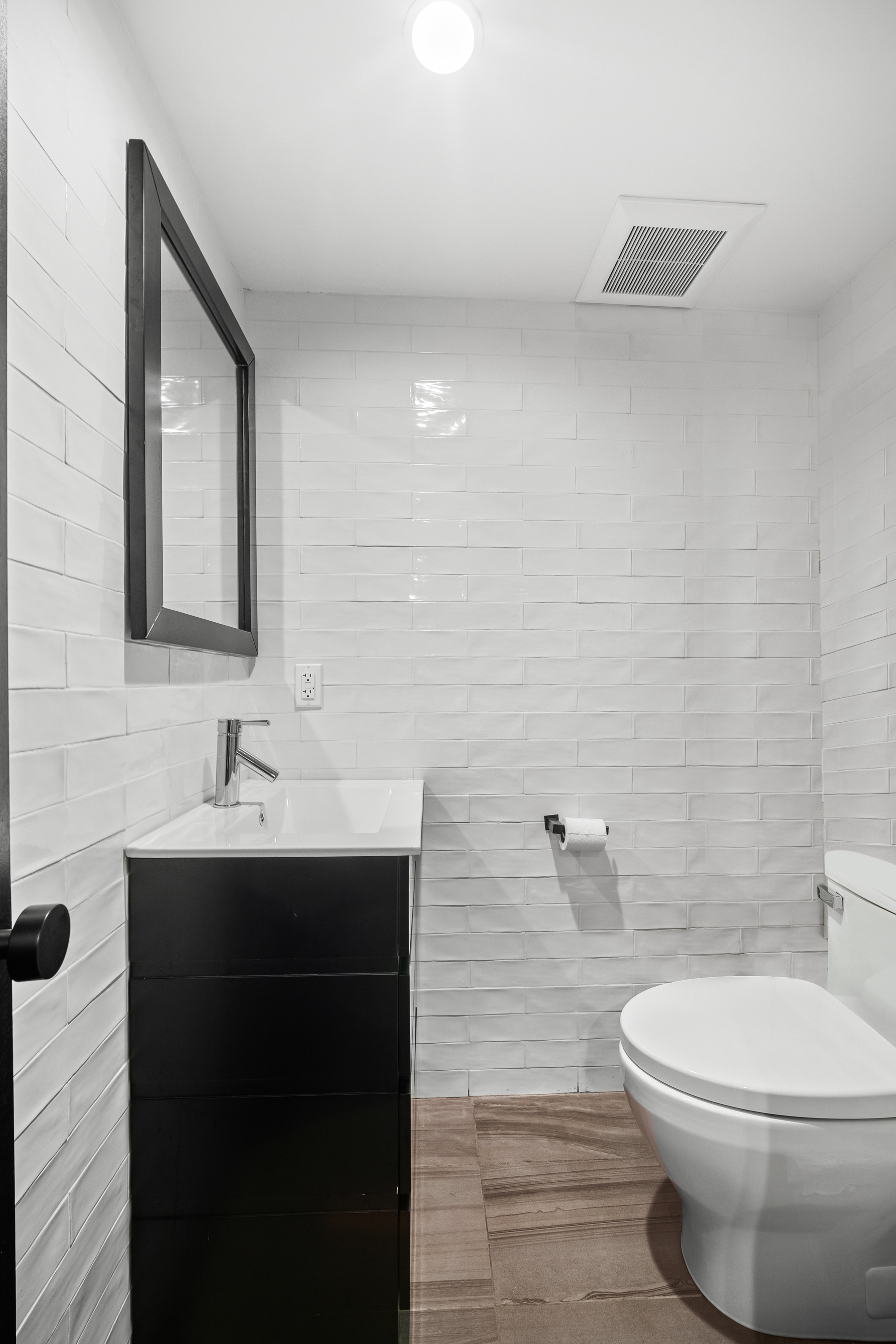 158 15th Street, Unit 1B Brooklyn, NY 11215 - Photo 12 of 14 a bathroom with a toilet sink and mirror