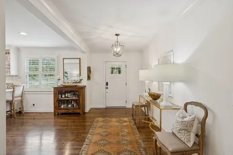 a living room with furniture fireplace and a piano