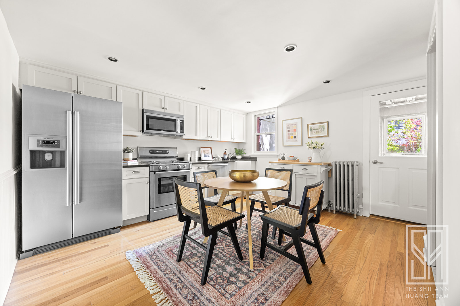 195 A 8th Street Brooklyn, NY 11215 - Photo 14 of 26 a kitchen with stainless steel appliances a dining table chairs refrigerator and sink