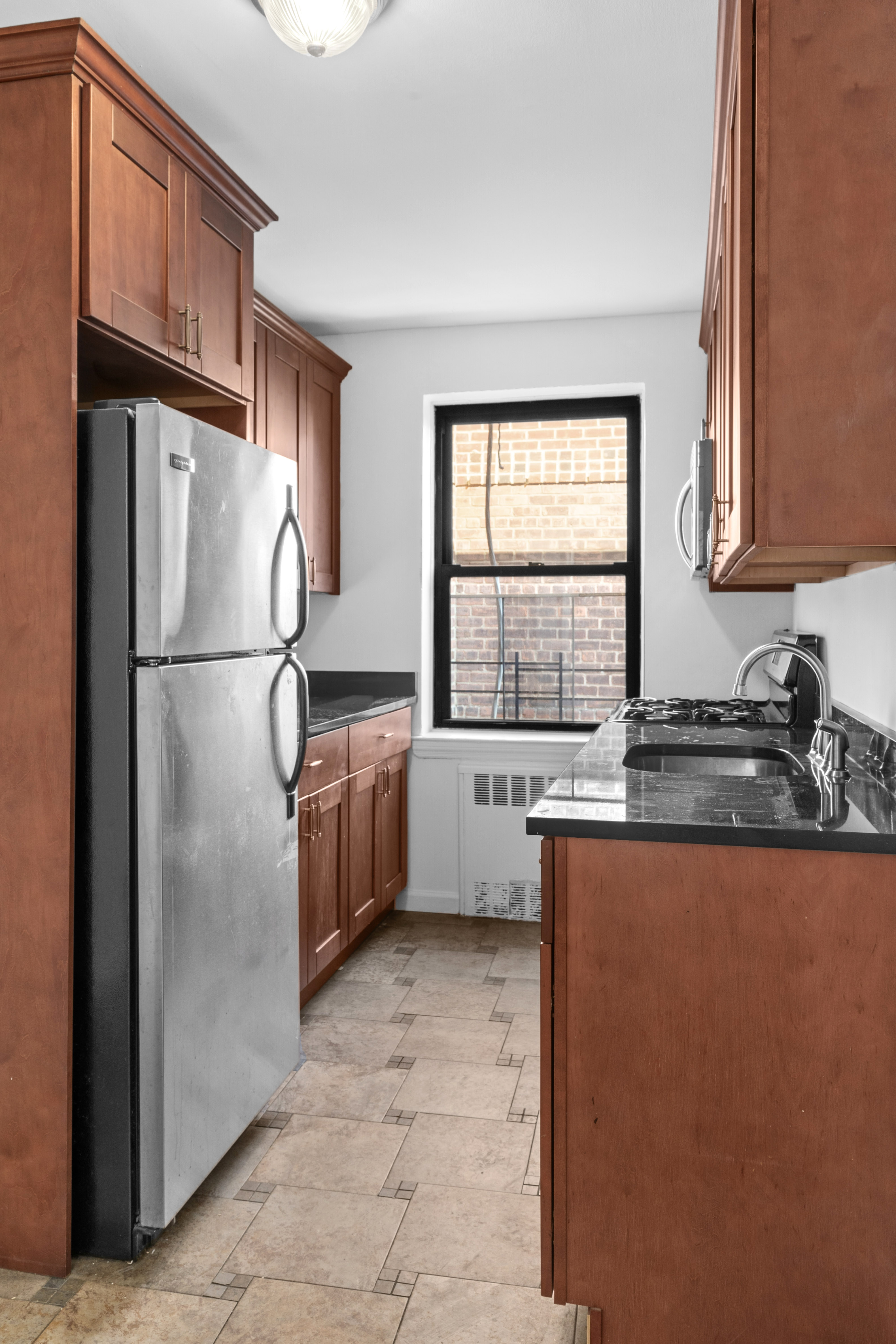 145 72nd Street, Unit F7 Brooklyn, NY 11209 - Photo 6 of 9 a kitchen with stainless steel appliances granite countertop a refrigerator a sink a stove and a refrigerator