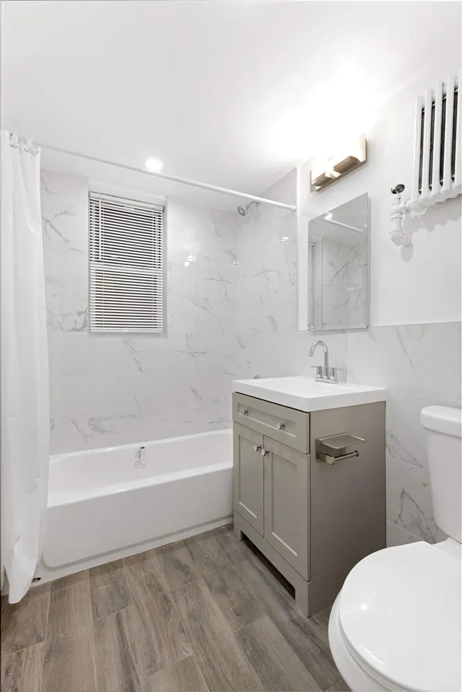 a bathroom with a sink a toilet and bathtub