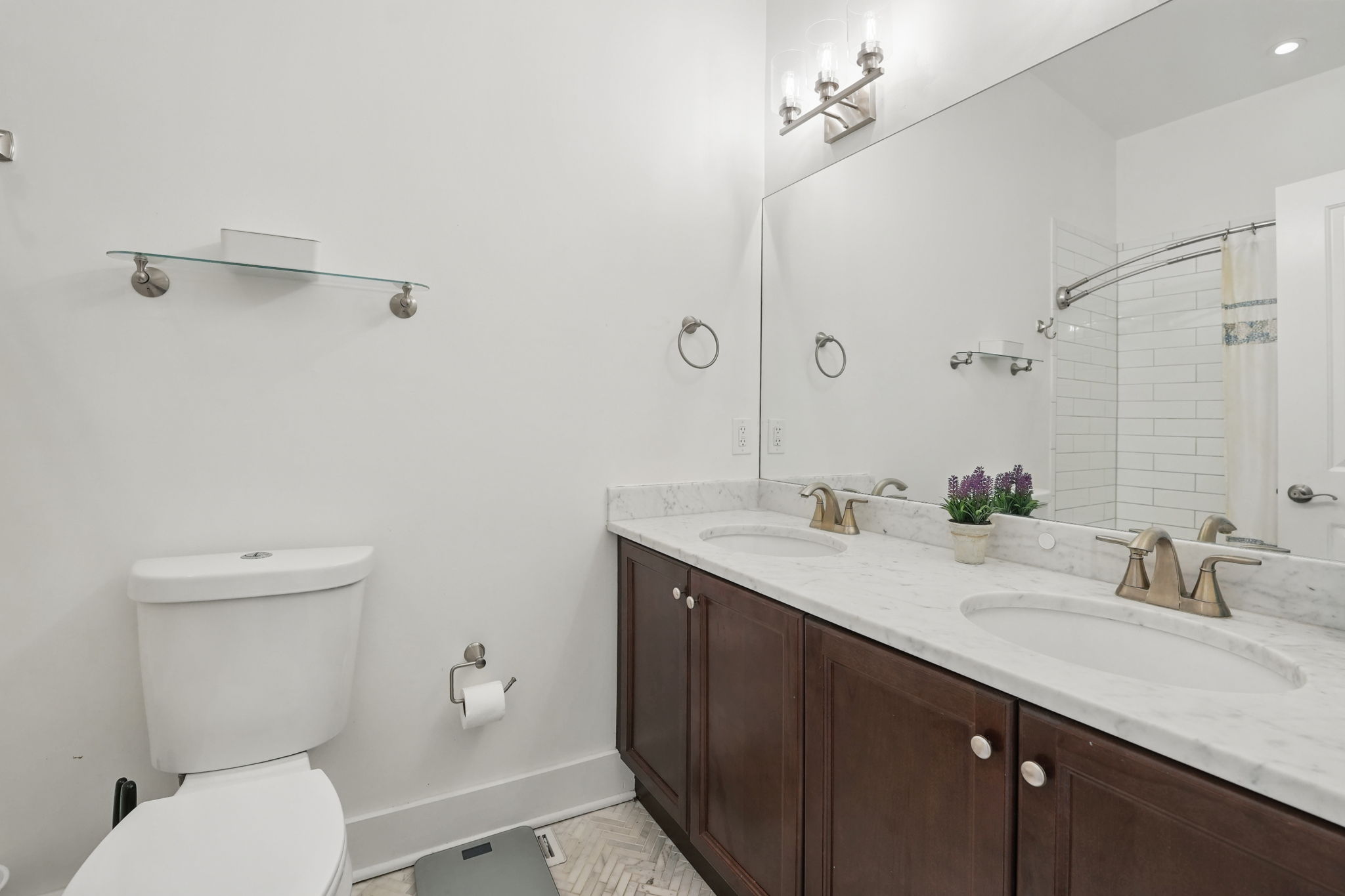 28 Q Street Northeast, Unit 2 Washington, DC 20002 - Photo 28 of 41 a bathroom with a granite countertop sink a toilet and a mirror