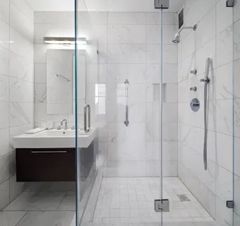 a bathroom with a shower sink and mirror