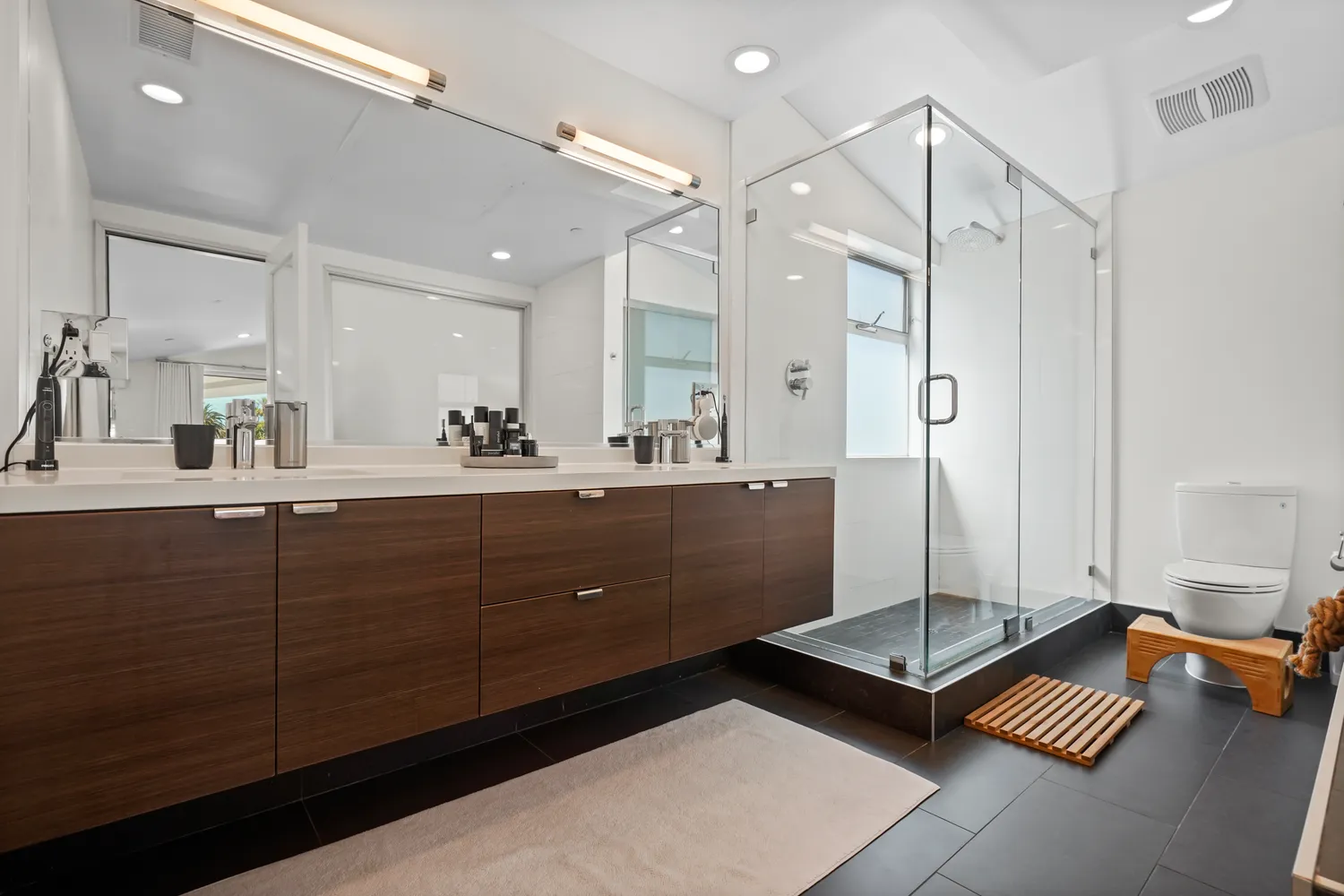 a bathroom with a double vanity sink mirror and double