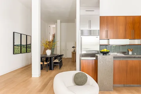 a kitchen with stainless steel appliances granite countertop a refrigerator and a stove top oven