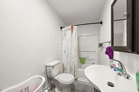 a bathroom with a sink toilet and shower
