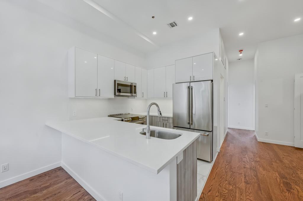 109 President Street, Unit 2 Brooklyn, NY 11231 - Photo 2 of 20 a kitchen with stainless steel appliances a sink stove and refrigerator
