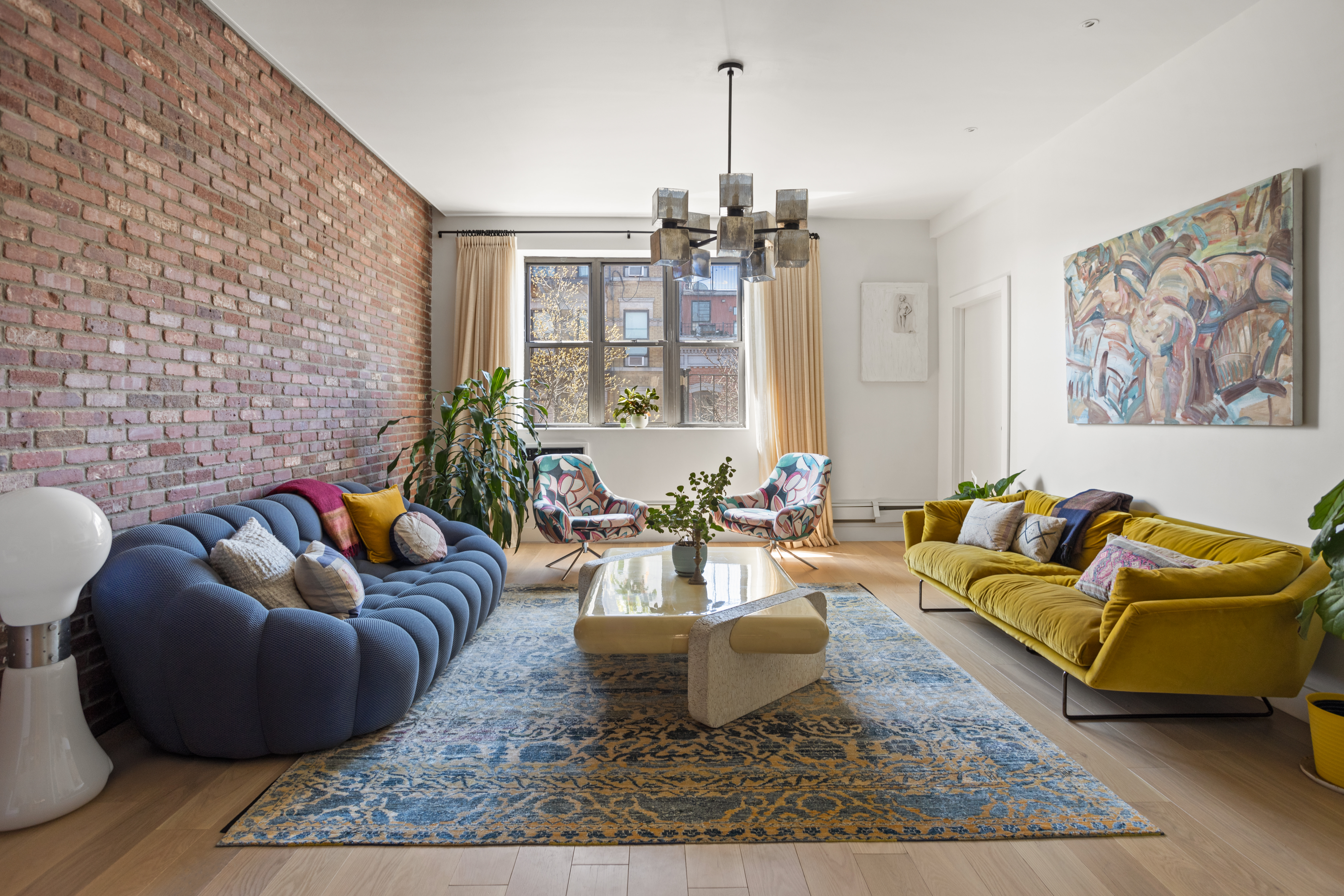 a living room with furniture and a chandelier