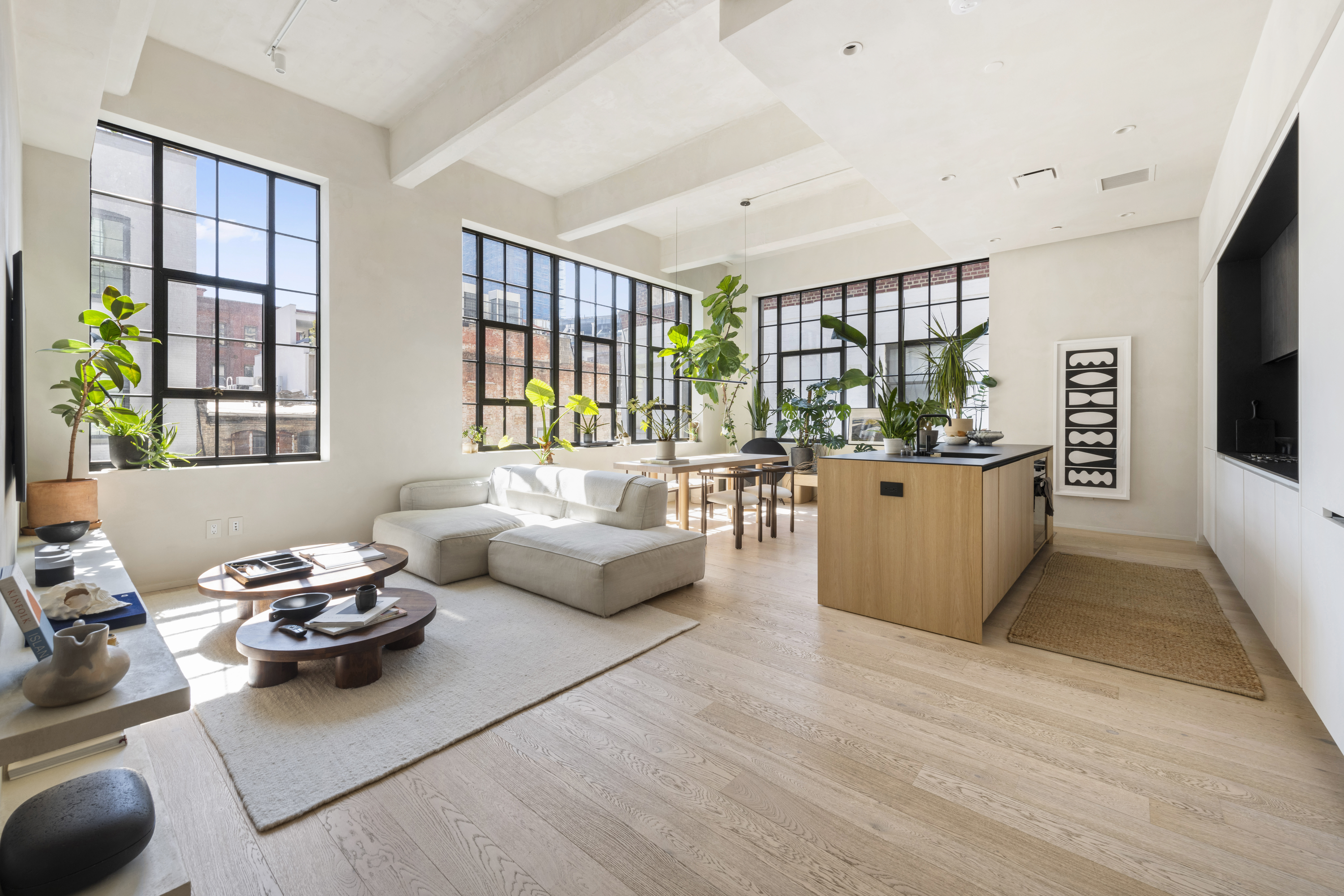 a living room with furniture and large windows