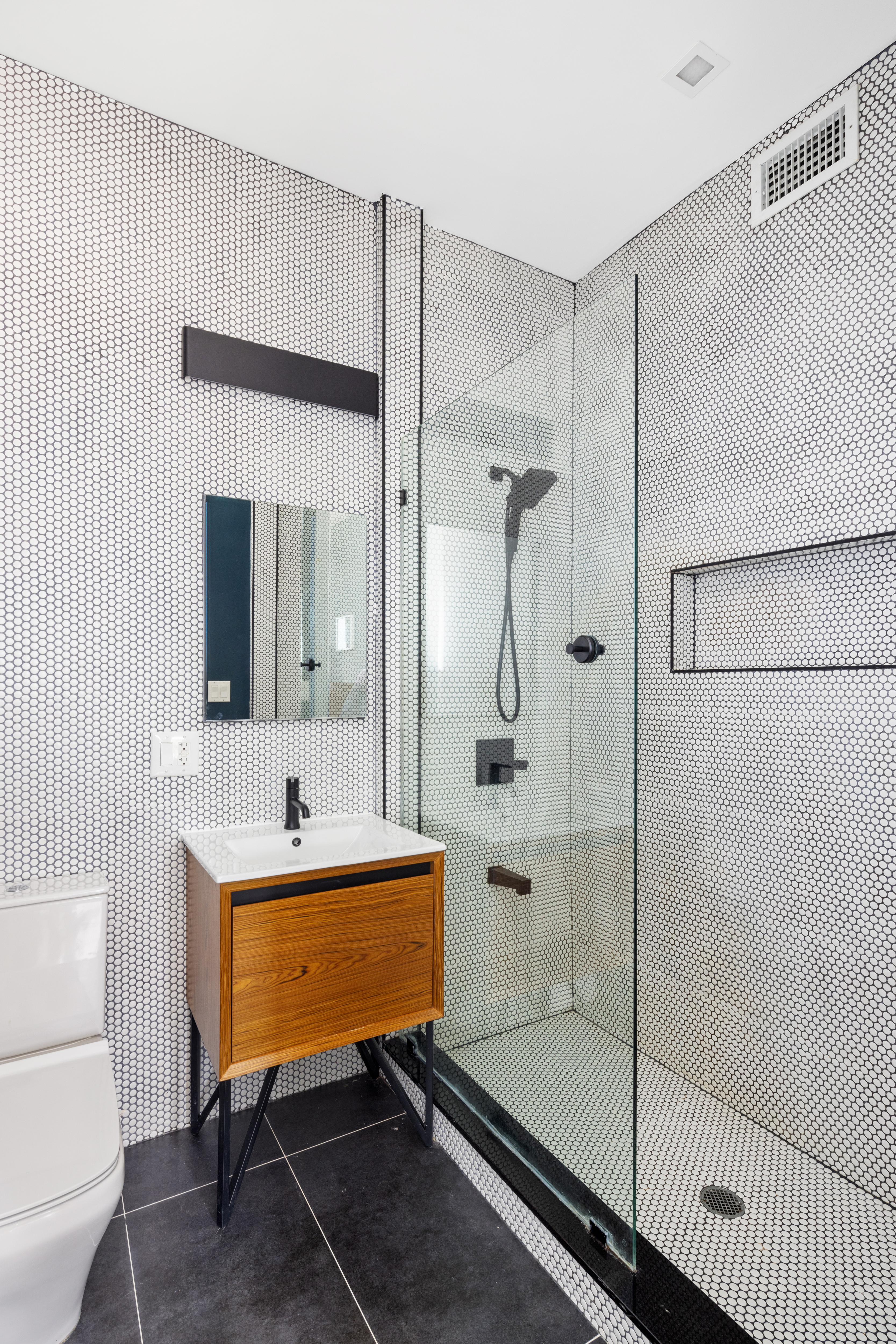 64 Stanhope Street, Unit PH Brooklyn, NY 11221 - Photo 8 of 13 a bathroom with a sink toilet a mirror and shower