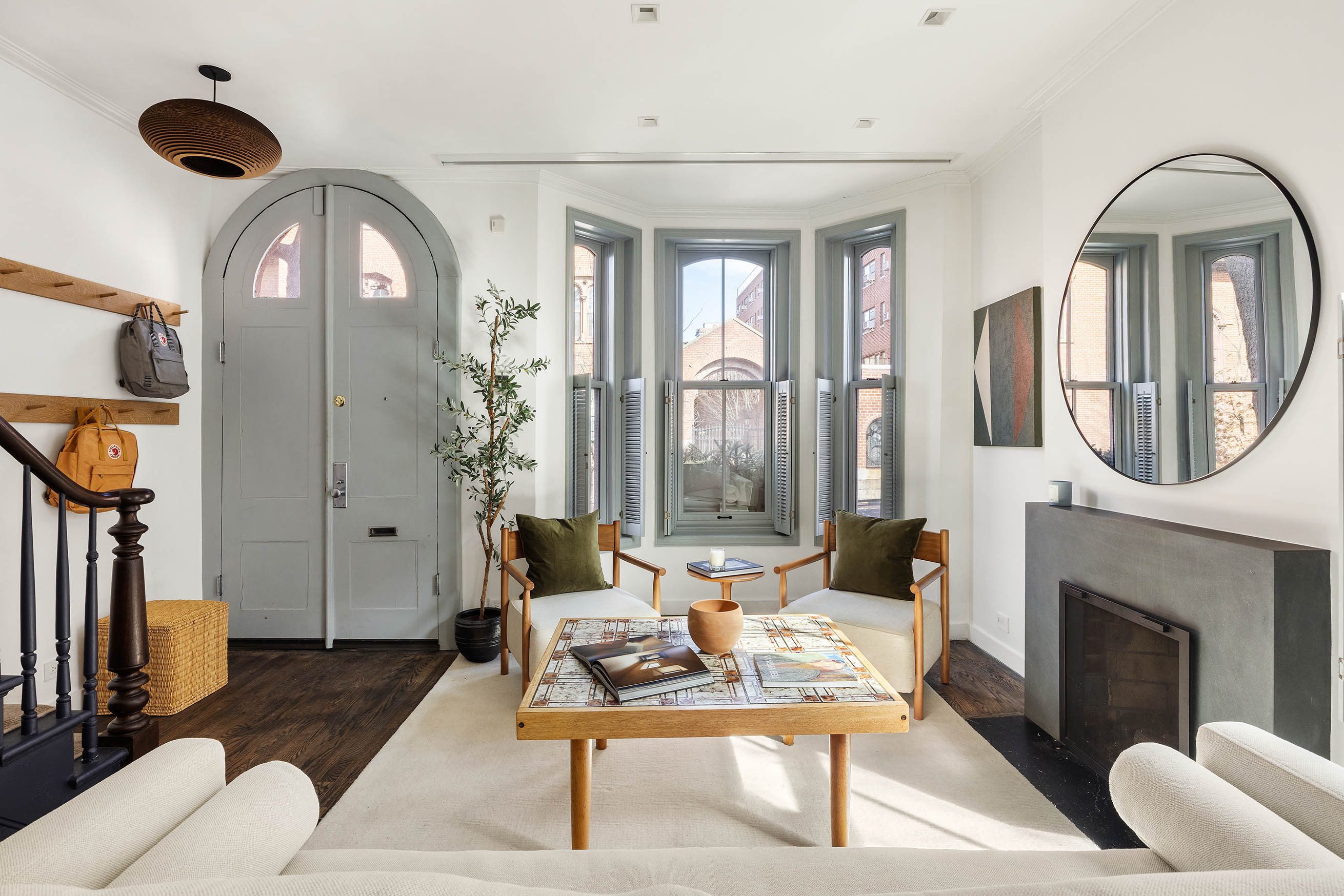 148 Warren Street Brooklyn, NY 11201 - Photo 4 of 20 a living room with furniture a fireplace and a chandelier