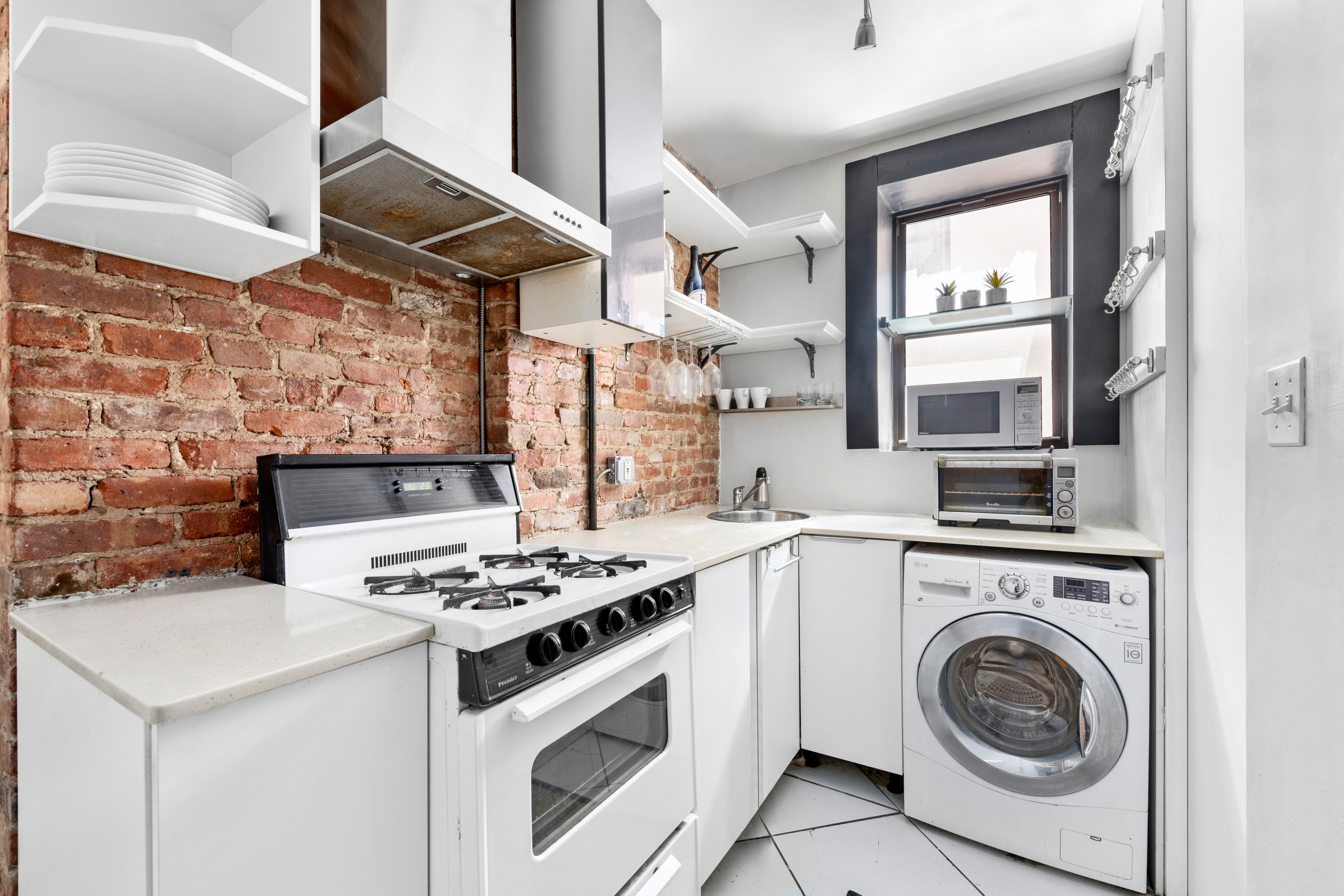321 East 12th Street, Unit 24 Manhattan, NY 10003 - Photo 3 of 8 a kitchen with a stove and a sink