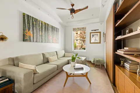 a living room with furniture and a kitchen