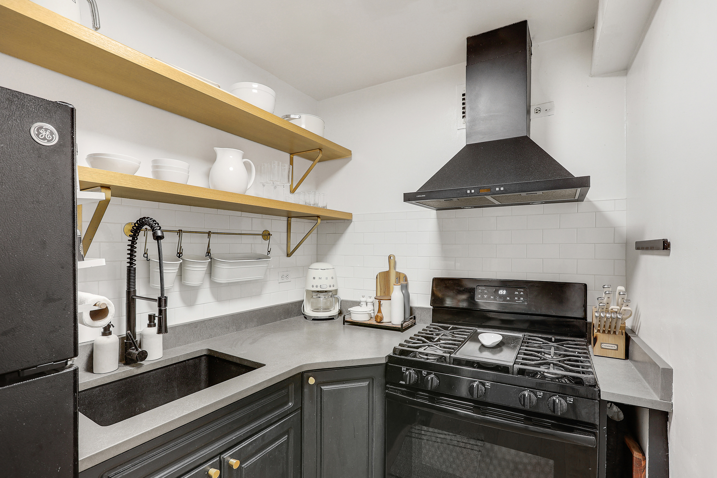 150 East 61st Street, Unit 2A Manhattan, NY 10065 - Photo 5 of 16 a kitchen with stainless steel appliances a stove and a sink