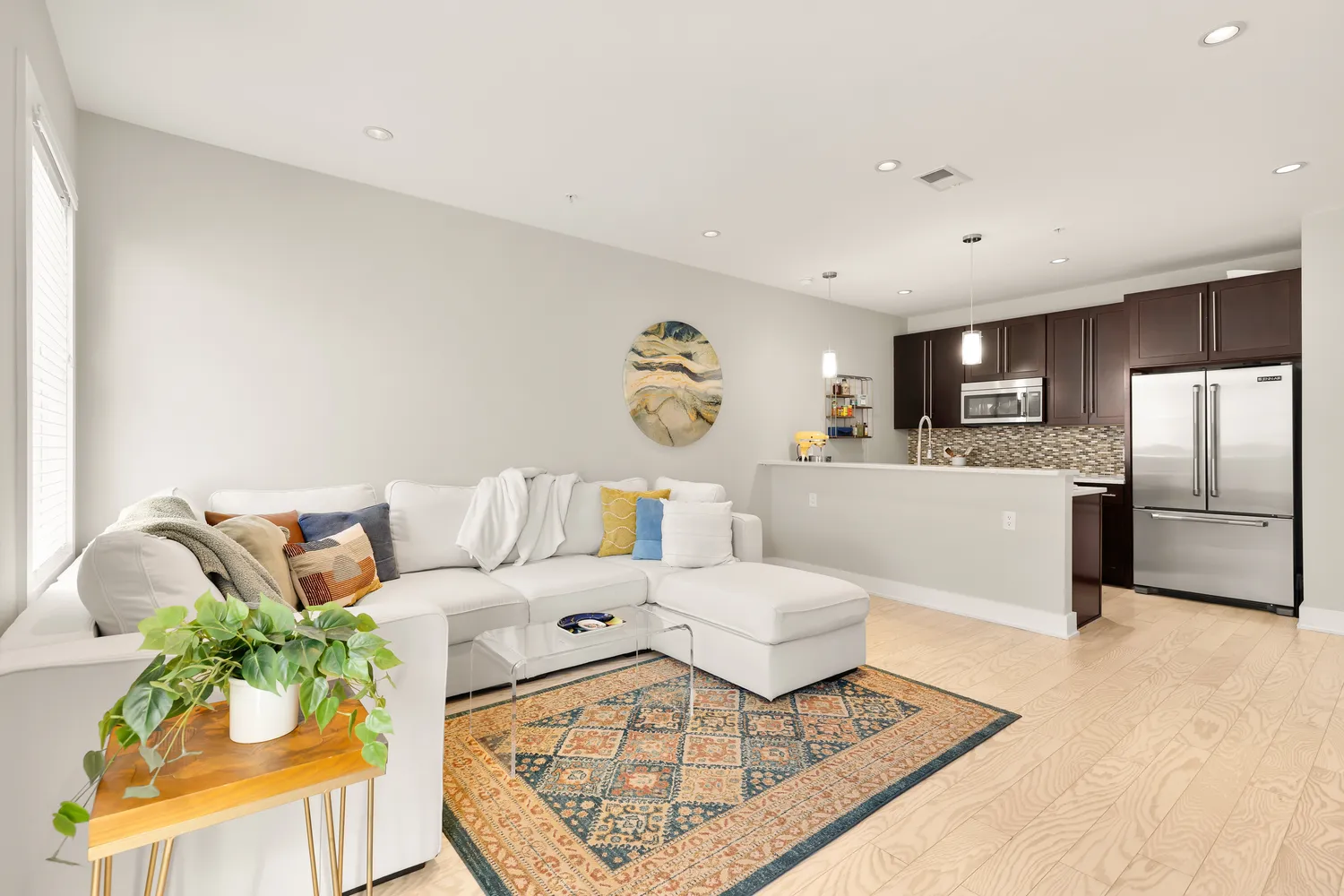 a living room with furniture and kitchen view