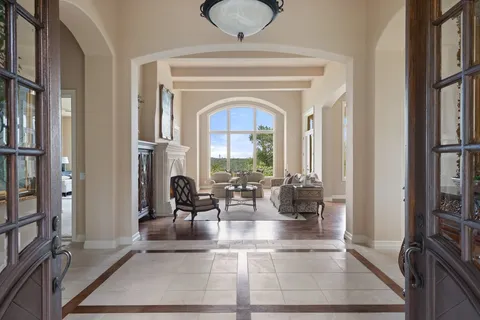 a dining room with furniture a chandelier and wooden floor
