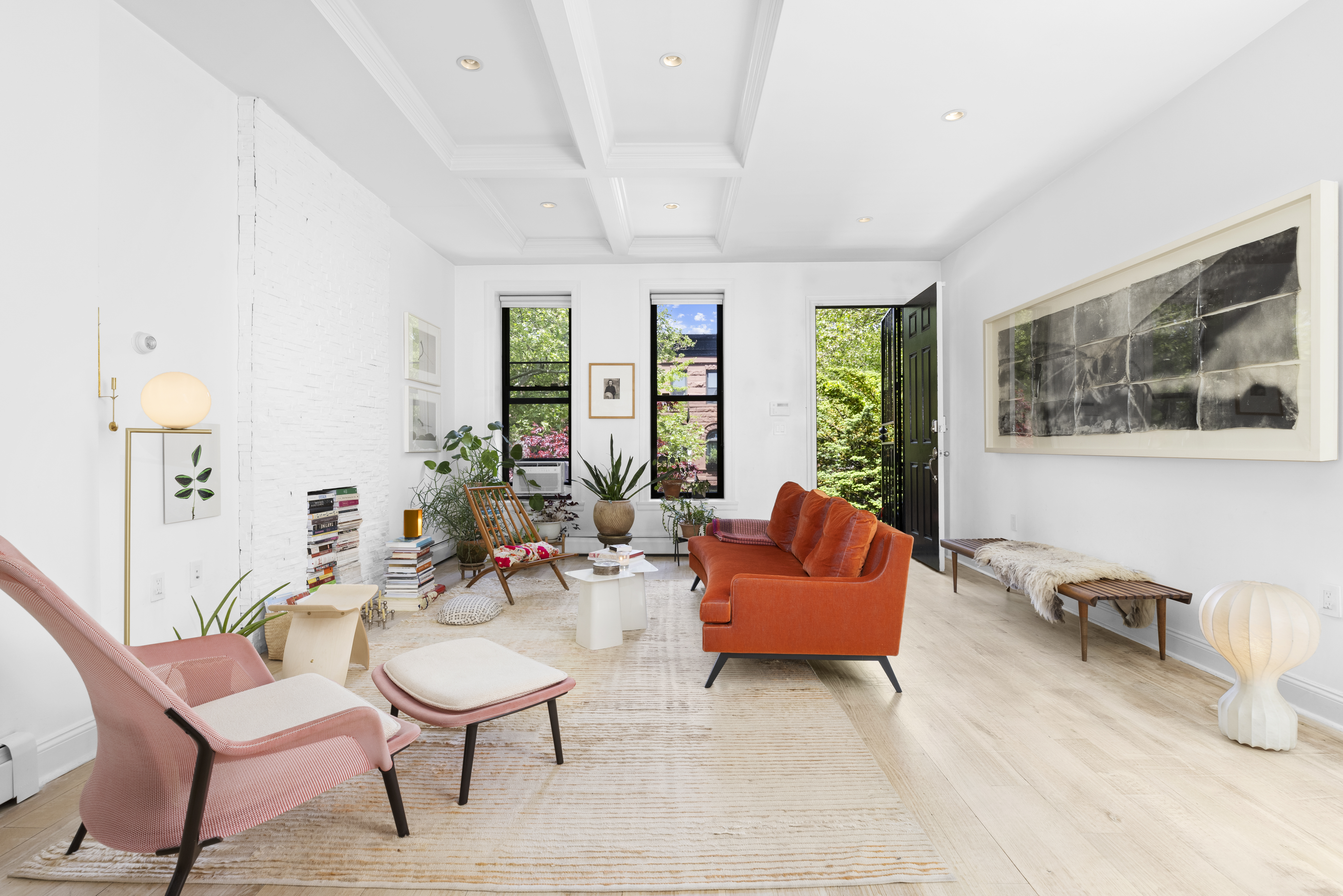 a living room with furniture and a potted plant