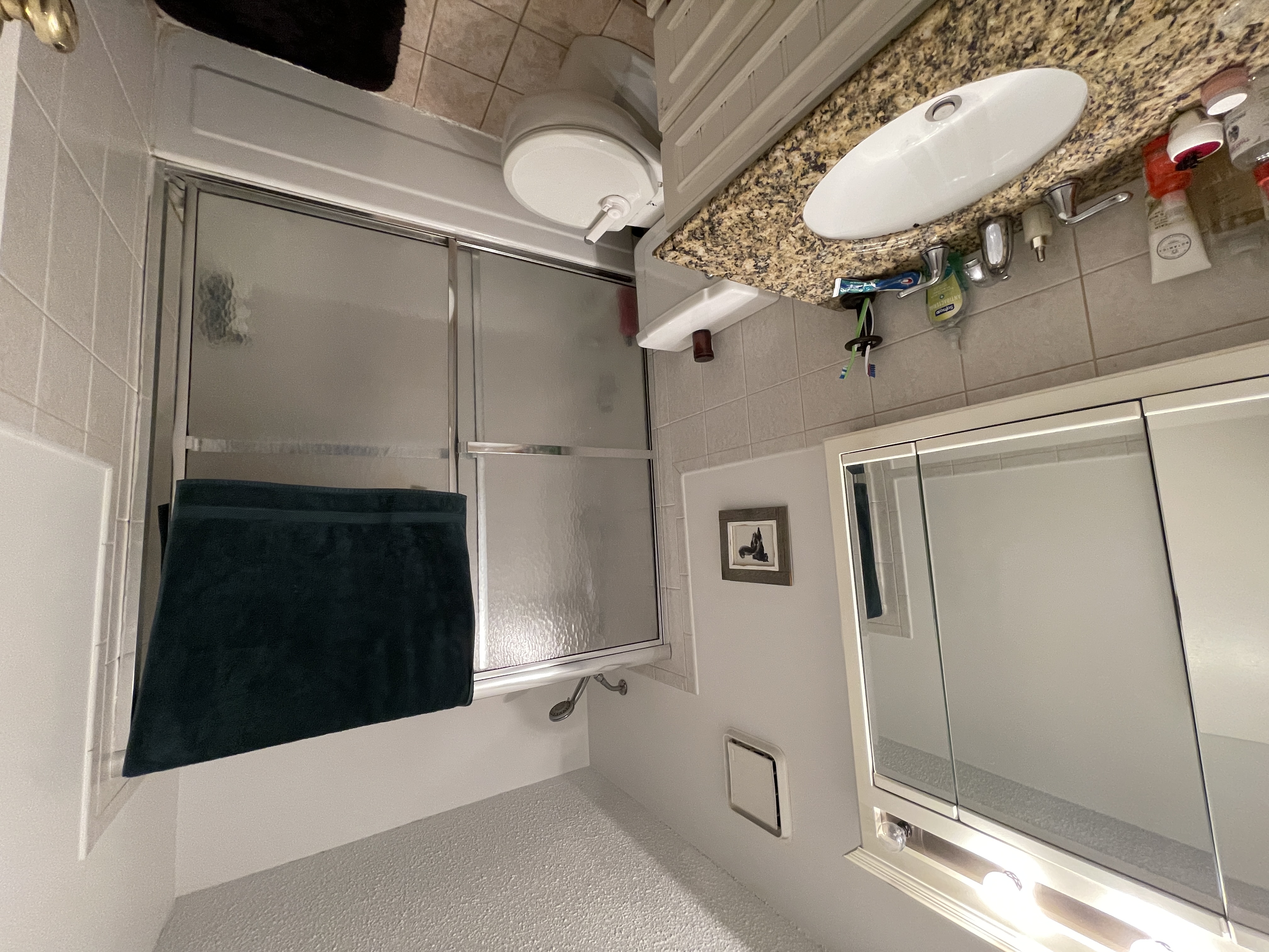 25-40 Shore Boulevard, Unit 5B Queens, NY 11102 - Photo 10 of 24 a bathroom with a granite countertop sink toilet and shower