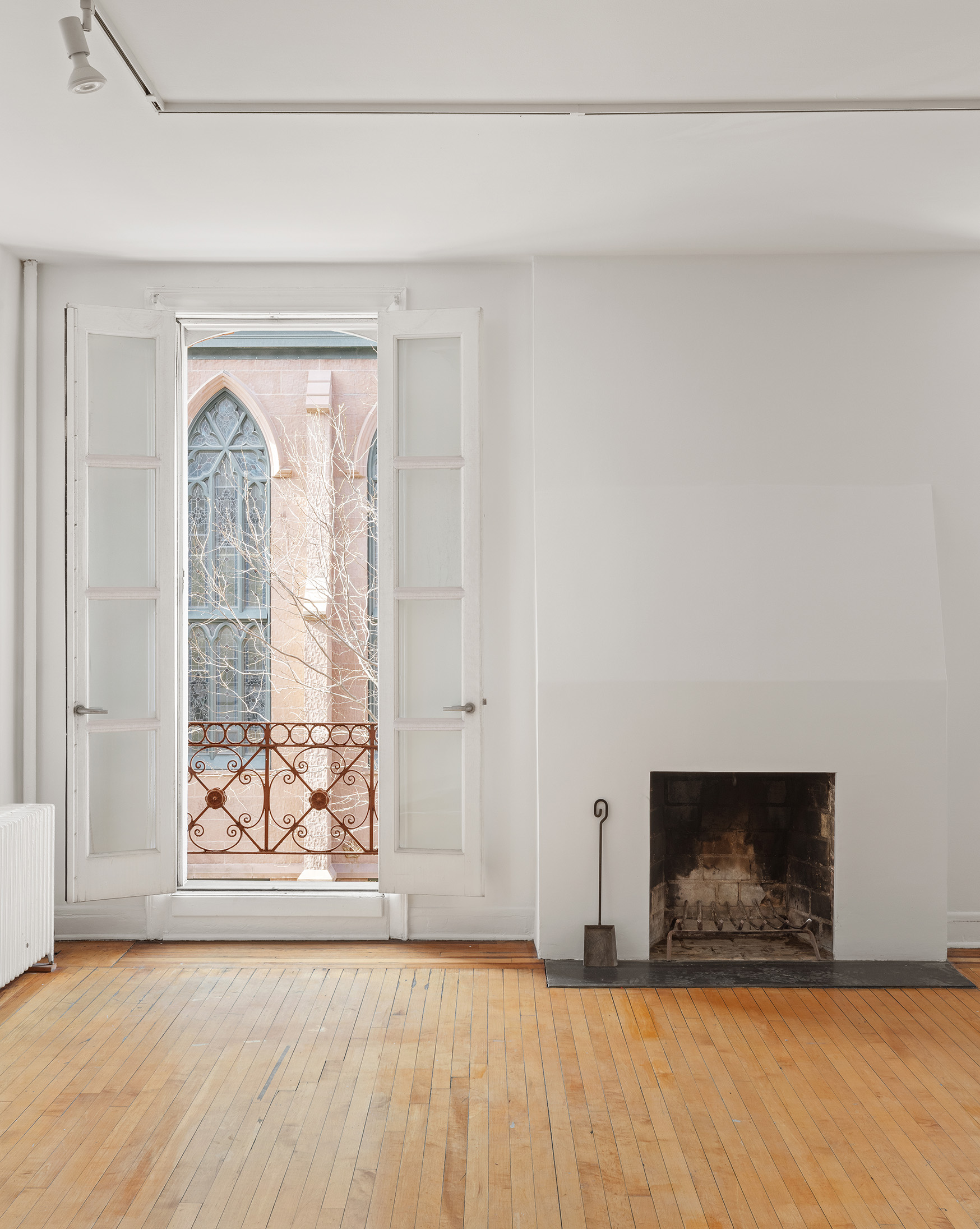 295 East 8th Street, Unit 2/3E Manhattan, NY 10009 - Photo 11 of 23 a view of an empty room with wooden floor and a window