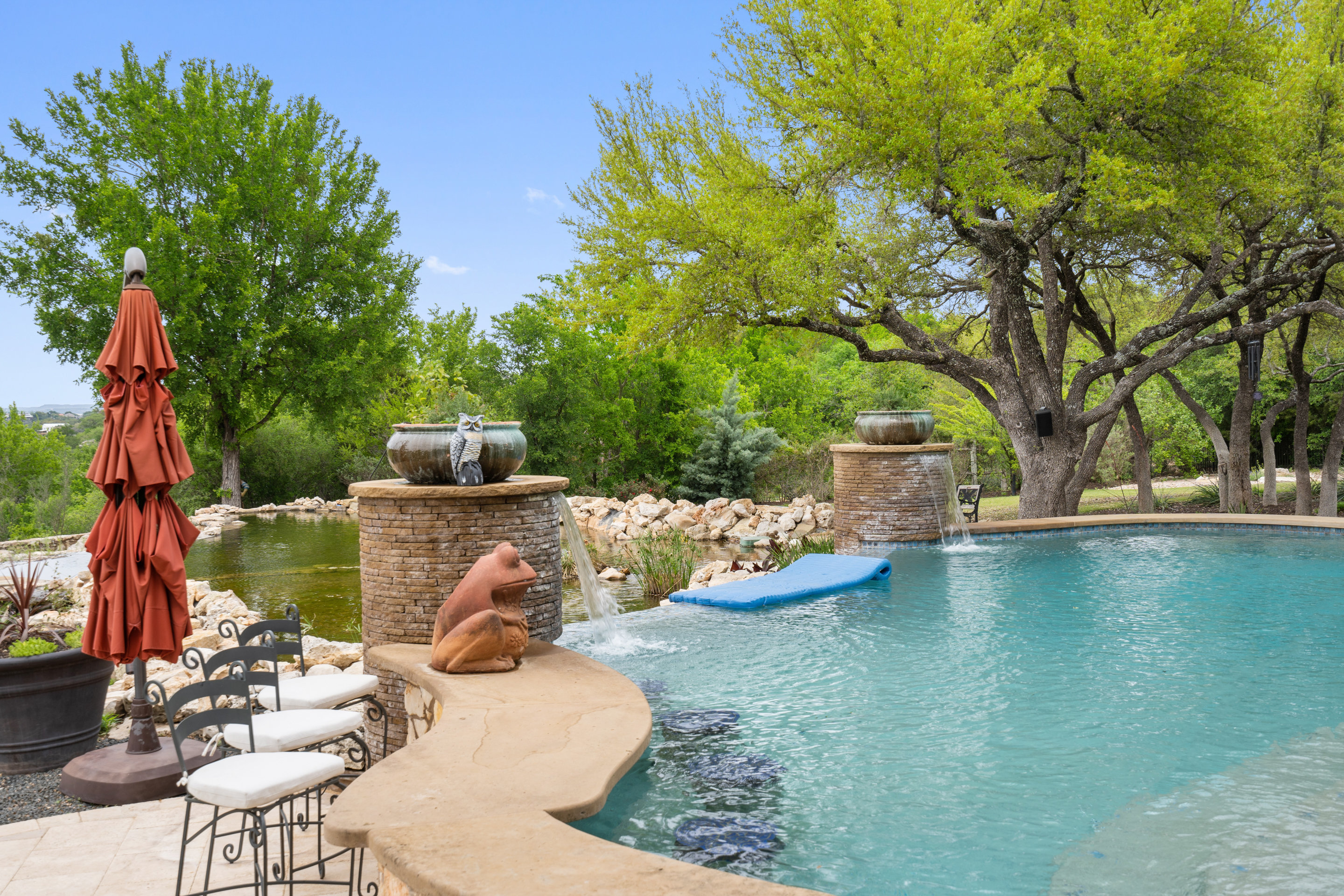 808 Rivercliff Drive Spicewood, TX 78669 - Photo 26 of 71 a view of a patio with table and chairs potted plants and large tree