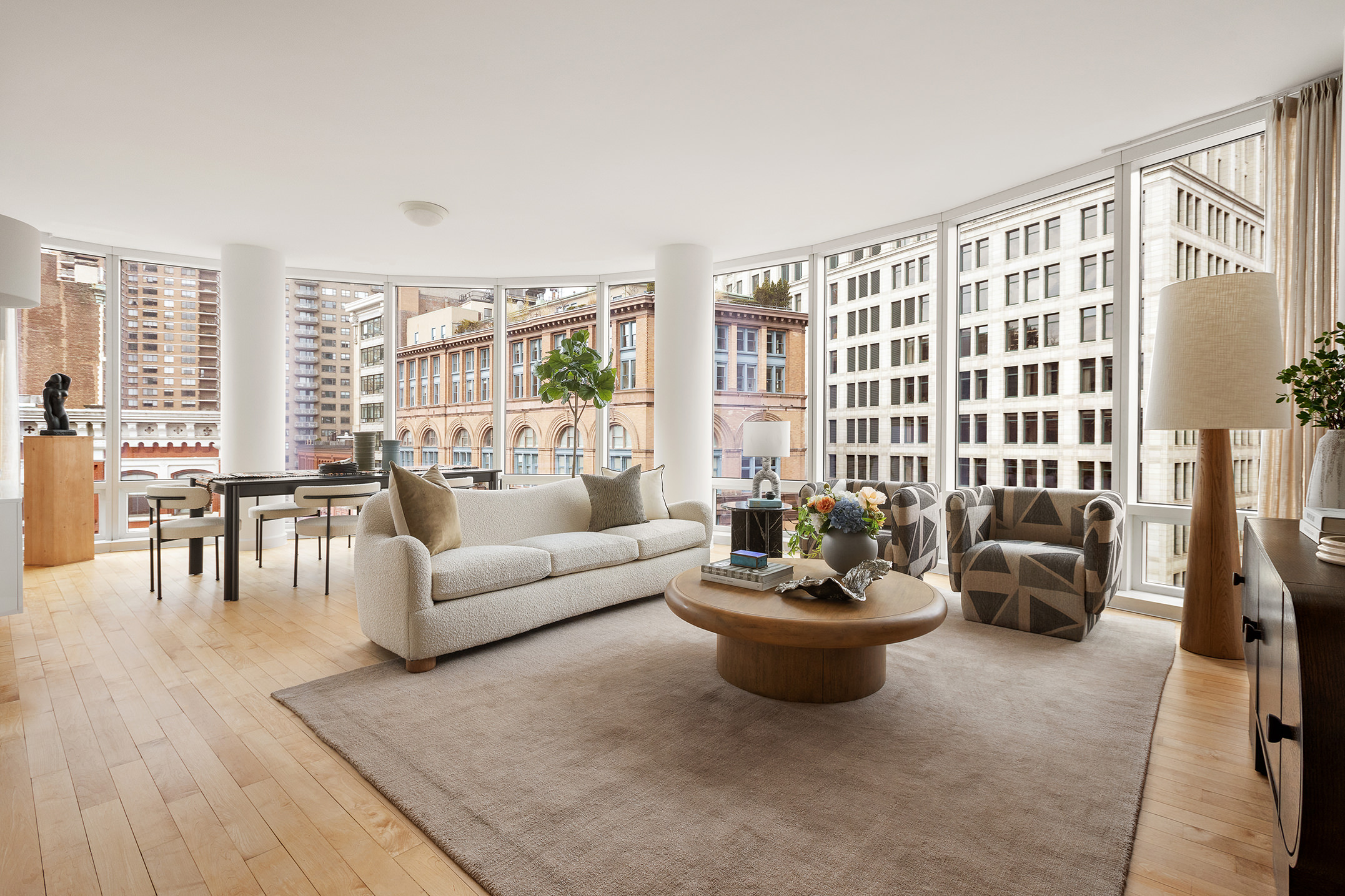 a living room with furniture and a potted plant