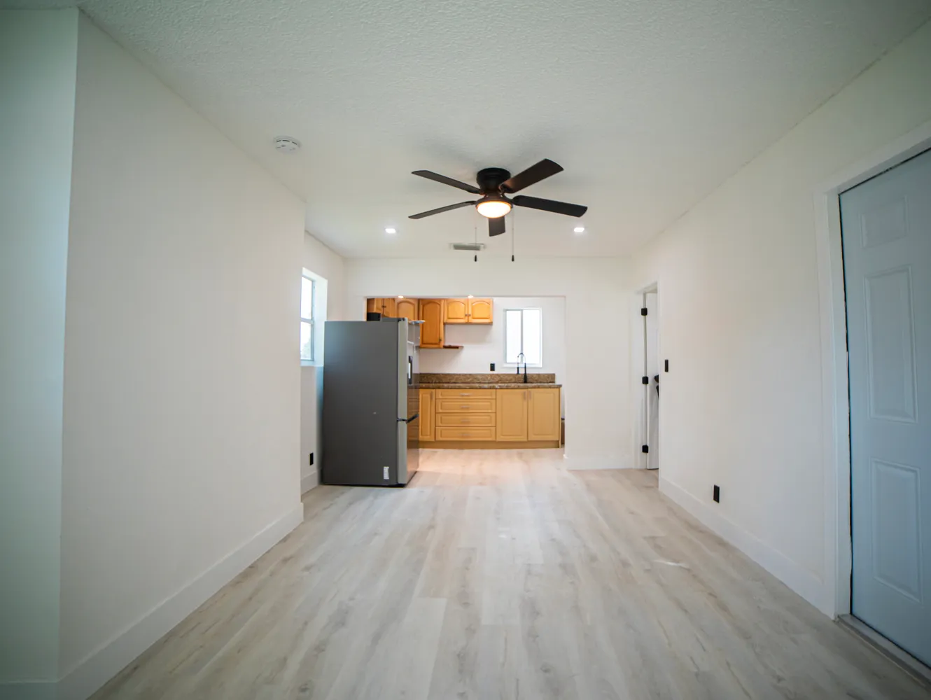 a view of a kitchen with a sink and a refrigerator