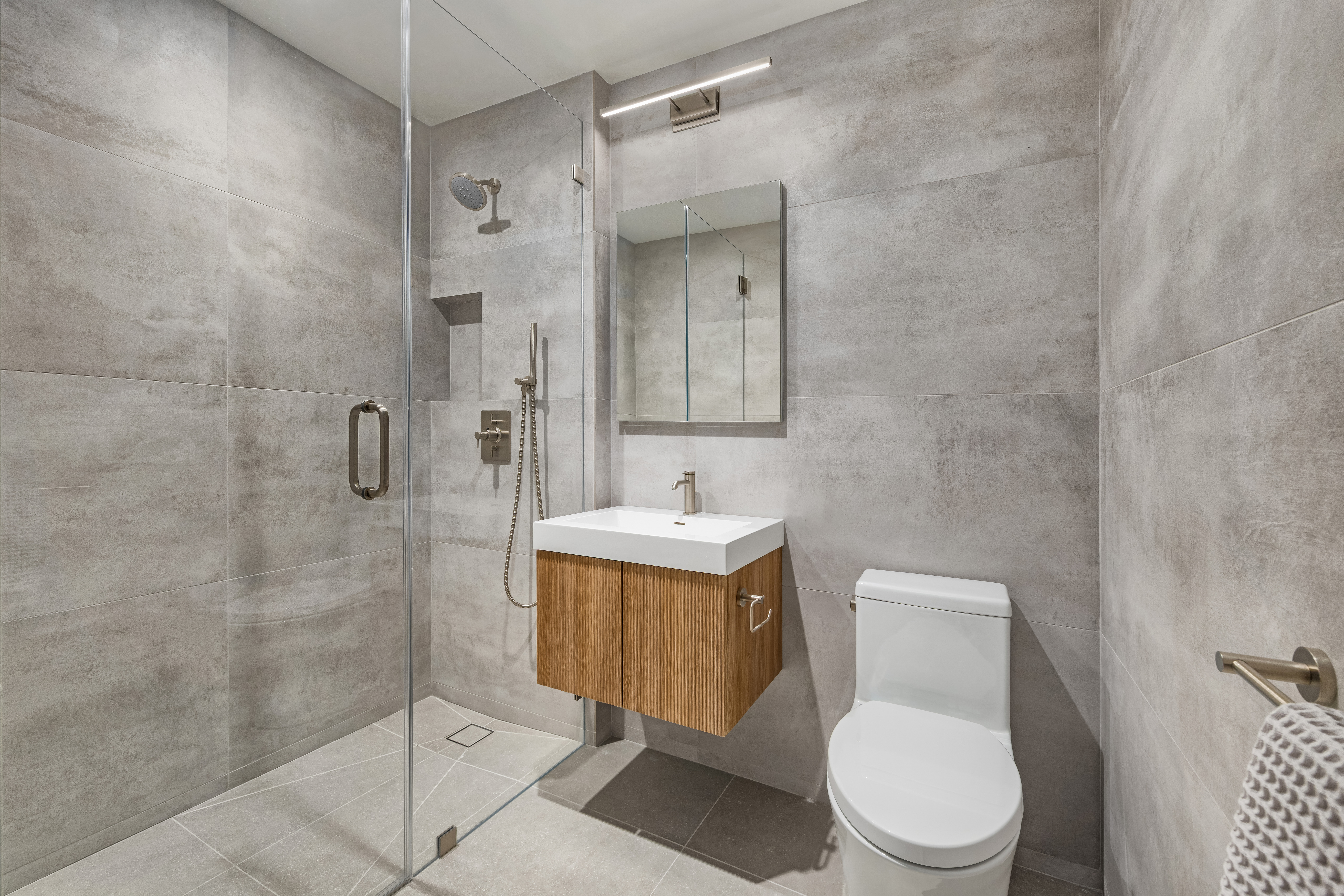 404 East 76th Street, Unit 2B Manhattan, NY 10021 - Photo 15 of 24 a white toilet sitting next to a bathroom sink