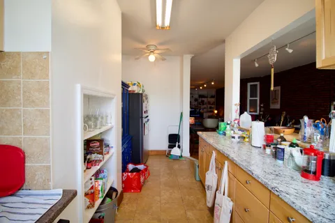 a kitchen that has a lot of cabinets and toilet