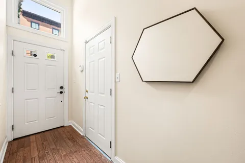 a view of a livingroom with wooden floor and white walls
