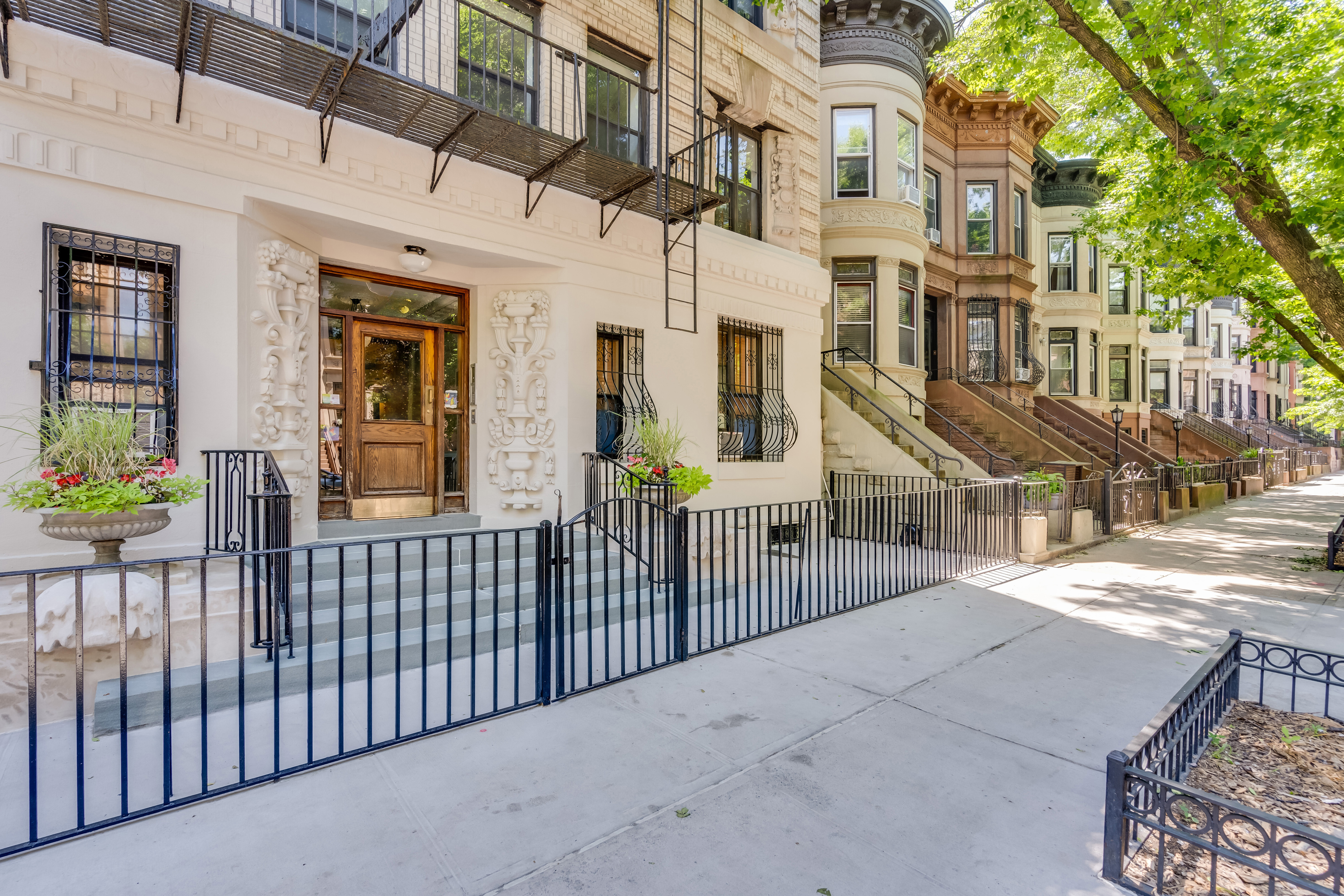 430 Sterling Place, Unit 2B Brooklyn, NY 11238 - Photo 12 of 14 a view of a house with a wooden fence