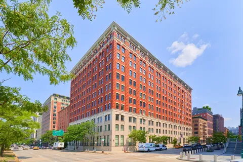a view of a tall building next to a road